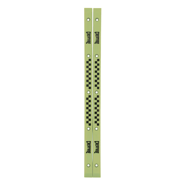 The CREATURE SLIDERS RAILS GLOW IN THE DARK by SANTA CRUZ are two parallel, light green metal bars adorned with black checkered patterns and the text "Departure" repeatedly printed. These slimline rails feature multiple holes along their length and add a sleek touch reminiscent of Santa Cruz’s stylish designs.