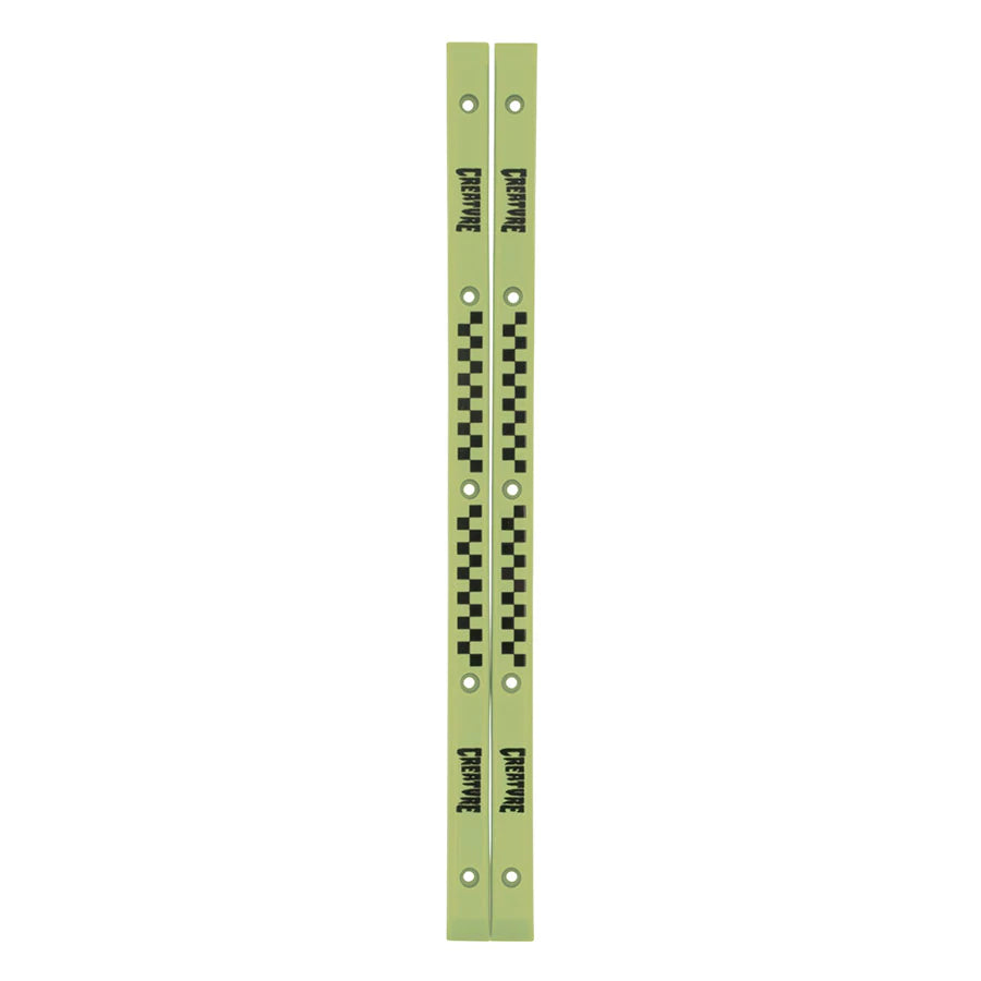 The CREATURE SLIDERS RAILS GLOW IN THE DARK by SANTA CRUZ are two parallel, light green metal bars adorned with black checkered patterns and the text "Departure" repeatedly printed. These slimline rails feature multiple holes along their length and add a sleek touch reminiscent of Santa Cruz’s stylish designs.