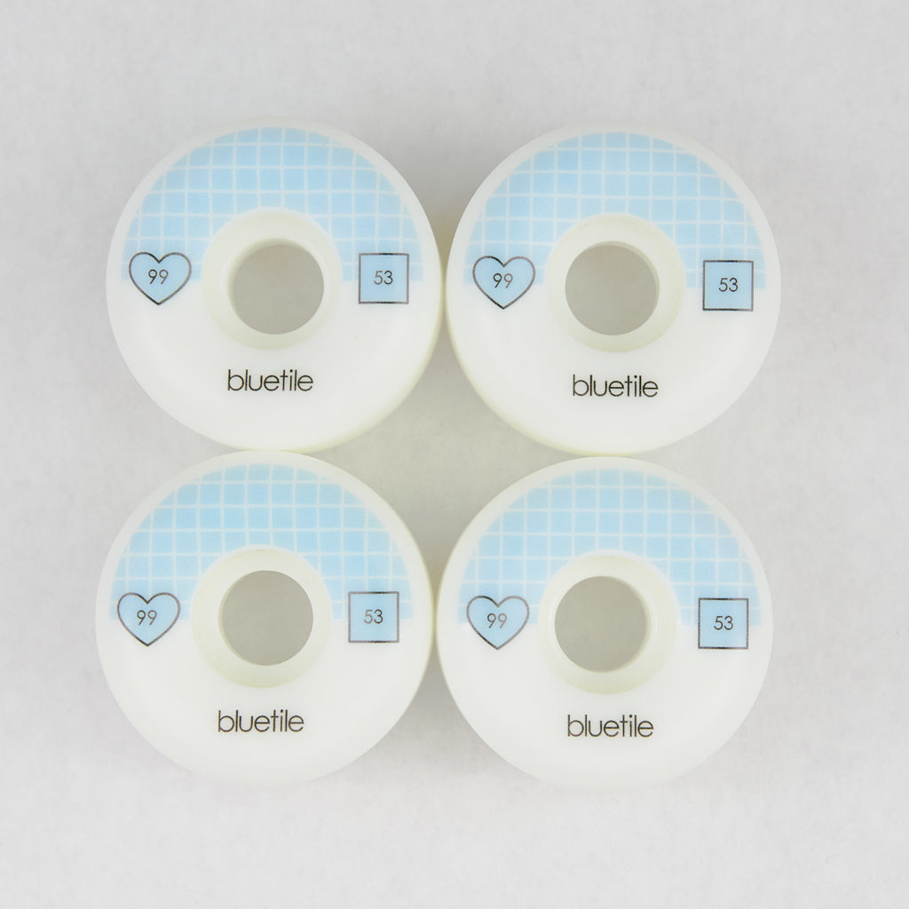 Four Bluetile skateboard wheels with blue hearts on them, measuring 53mm in size.