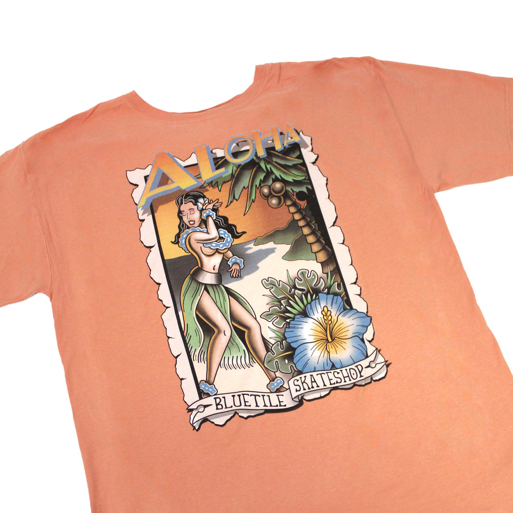 A BLUETILE ALOHA T-SHIRT CLAY with an image of a Hawaiian girl and a palm tree, made by Bluetile Skateboards.