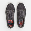A pair of VANS SKATE X QUASI OLD SKOOL ASPHALT sneakers with a red and blue label.