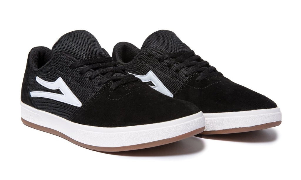 A pair of black and white LAKAI BRIGHTON BLACK SUEDE sneakers with white soles.