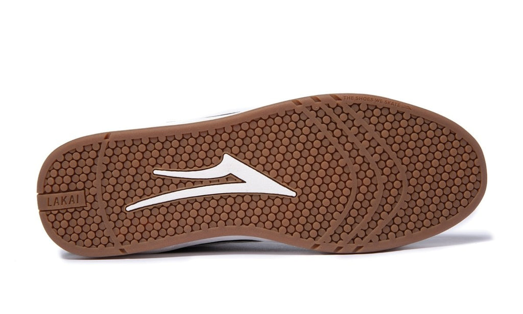 A pair of LAKAI flip flops with a white and brown sole.