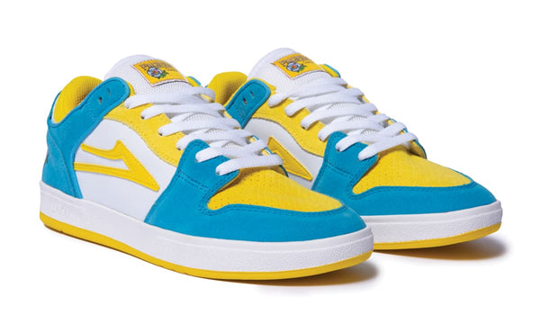 A pair of blue and yellow LAKAI X PACIFICO TELFORD LOW WHITE/CYAN SUEDE sneakers with yellow accents.