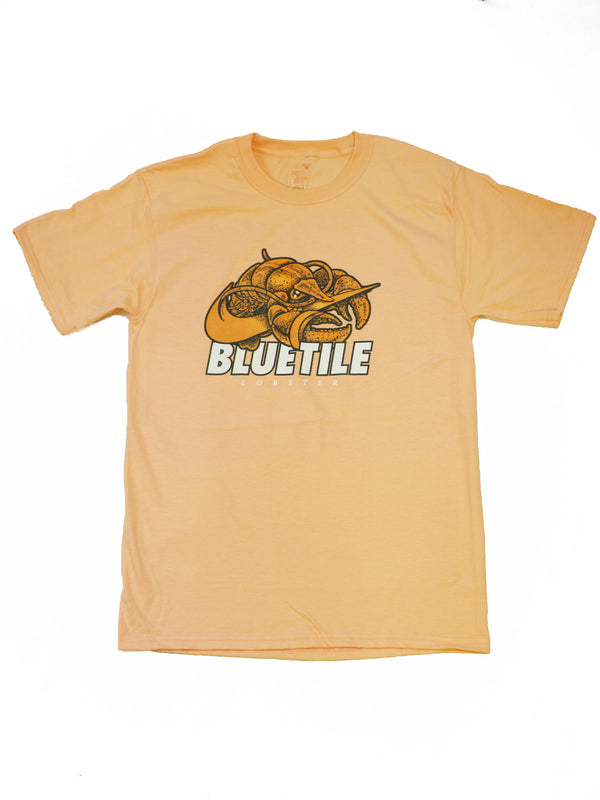 A yellow BLUETILE ORANGE LOBSTER T-SHIRT with a Bluetile Skateboards logo on it.