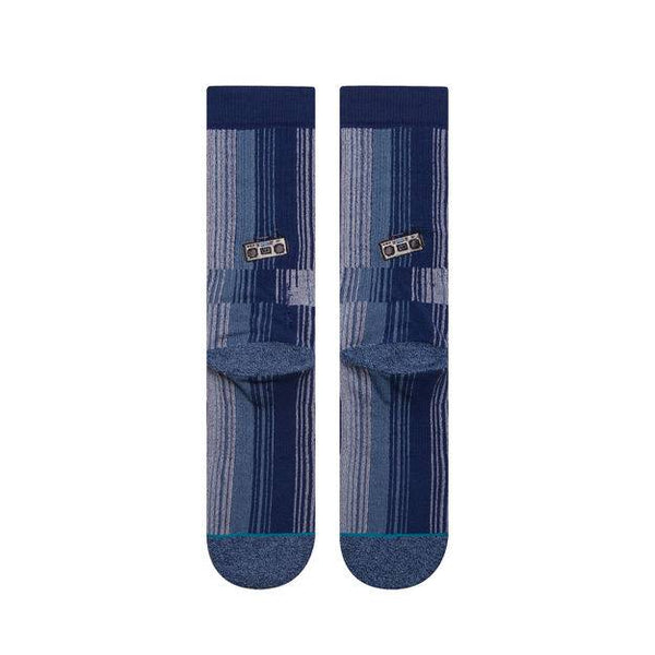 A pair of Stance Boombox Large striped blue dress socks with buckle patterns.