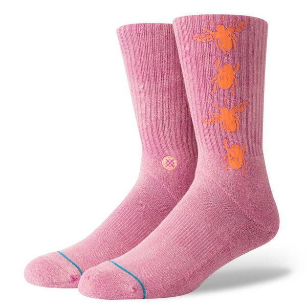 A pair of STANCE socks BUZZED MAGENTA LARGE with orange floral patterns and a blue detail on the toes.