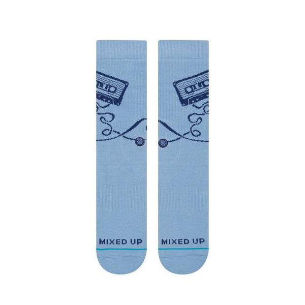 A pair of STANCE socks with whimsical designs and the words "mixed up" on the soles.