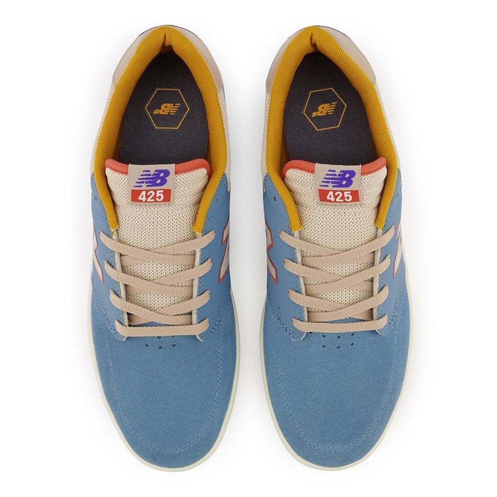 A pair of NB NUMERIC 425 BLUE / CREAM sneakers in blue and orange, specifically designed with the NB numeric logo.