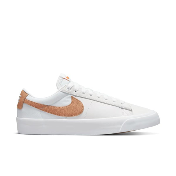 A white sneaker with a brown swoosh on the side, a white sole, and white laces—perfect for those looking to elevate their skate game with the style of nike NIKE SB BLAZER LOW PRO GT ISO WHITE / LIGHT COGNAC.