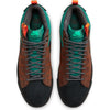 A pair of brown and green nike SB BLAZER MID PREMIUM NOBLE GREEN / BLACK shoes with laces.
