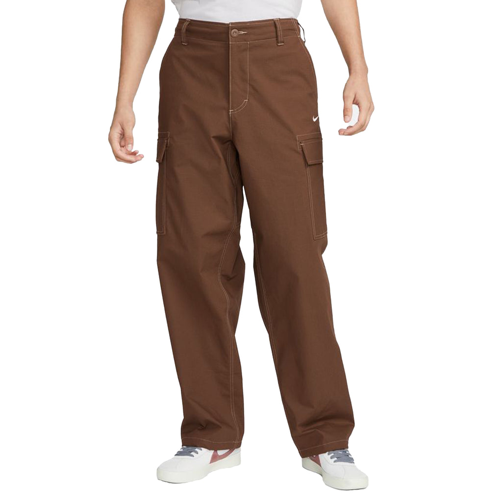 A man in a white shirt and brown Nike SB Kearny Skate Cargo Pant Cacao.