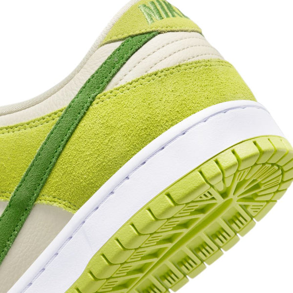 Close-up view of the back of a NIKE SB DUNK LOW PRO ATOMIC GREEN/CHLOROPHYLL sneaker by nike, showcasing light green suede, dark green stripes, and a white sole with atomic green tread.
