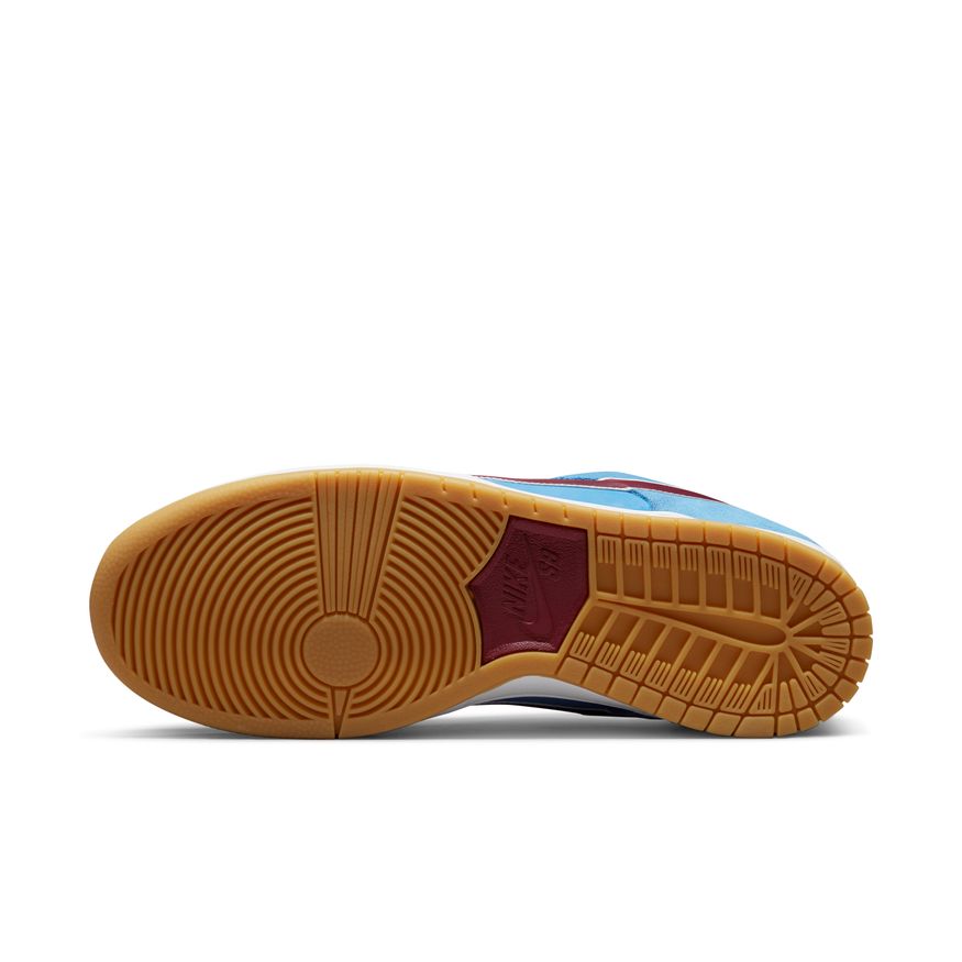 The sole of a NIKE SB DUNK LOW PRO "PHILLIES" VALOR BLUE/TEAM MAROON/WHITE shoe on a white surface.