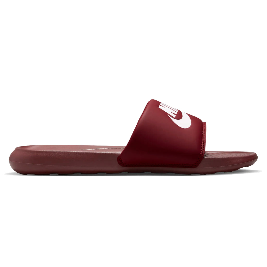 A red Nike SB Victor One slide sandal with a white Nike logo.