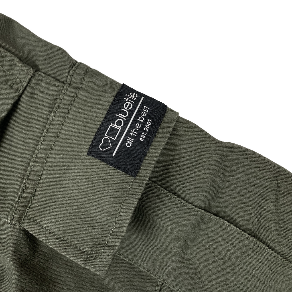 A close up of the label on a pair of durable & comfortable BLUETILE FORAGER CARGO PANT OLIVE GREEN pants by Bluetile Skateboards.
