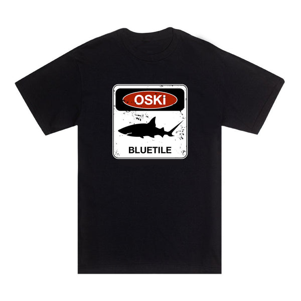 A BLUETILE BEWARE OF OSKI SHARK T-SHIRT BLACK, sporting the OSKI SHARK T-SHIRT design, by Bluetile Skateboards.
