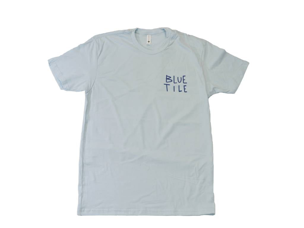 A BLUETILE LOVE LETTER T-SHIRT LIGHT BLUE designed by Irving Juarez as part of the artist series, featuring the phrase "Blue Tide" by Bluetile Skateboards.