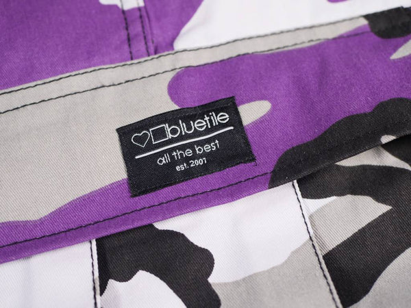 A Bluetile Skateboards Ultra Violet Purple camouflage jacket with a label on the back.
