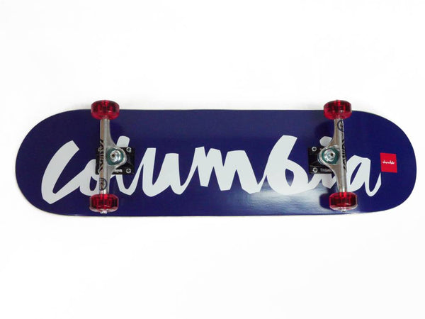 A skateboard with the word BLUETILE CHUNK COLUMBIA COMPLETE 8.5 written on its deck, manufactured by Bluetile Skateboards.
