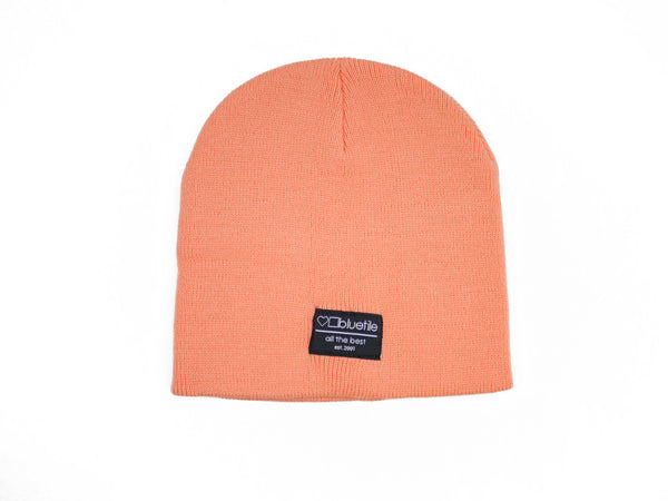 A BLUETILE SURPLUS UNCUFF BEANIE PEACH by Bluetile Skateboards on a white background.