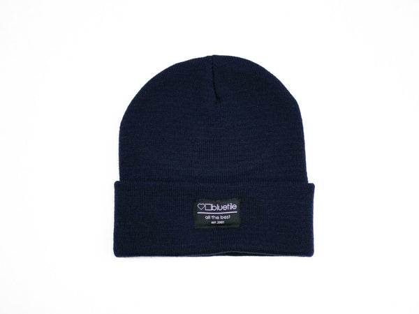 A BLUETILE SURPLUS BEANIE NAVY with a Bluetile Skateboards label on it.