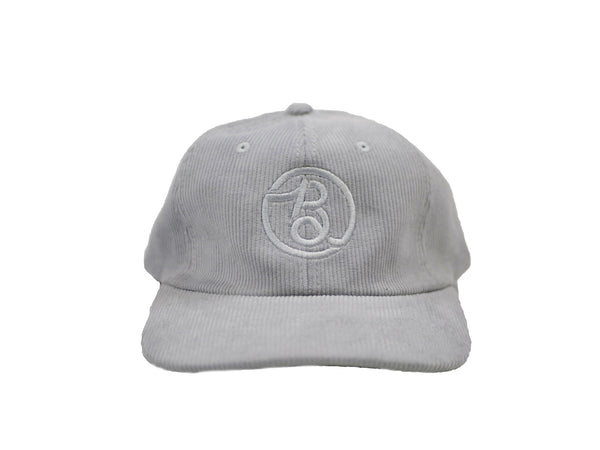 A Greytile Skateboards hat with a Bluetile Supply Co logo on it.