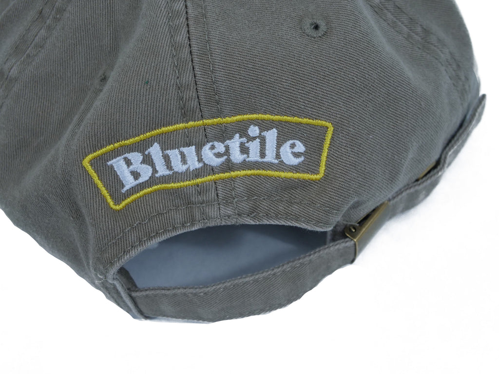 An UNSTRUCTURED gray hat with the word BLUETILE ALL THE BEST UNSTRUCTURED HAT COFFEE on it from Bluetile Skateboards.