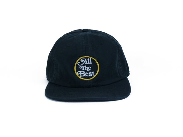 A BLUETILE ALL THE BEST UNSTRUCTURED HAT BLACK with a yellow patch on it from Bluetile Skateboards.