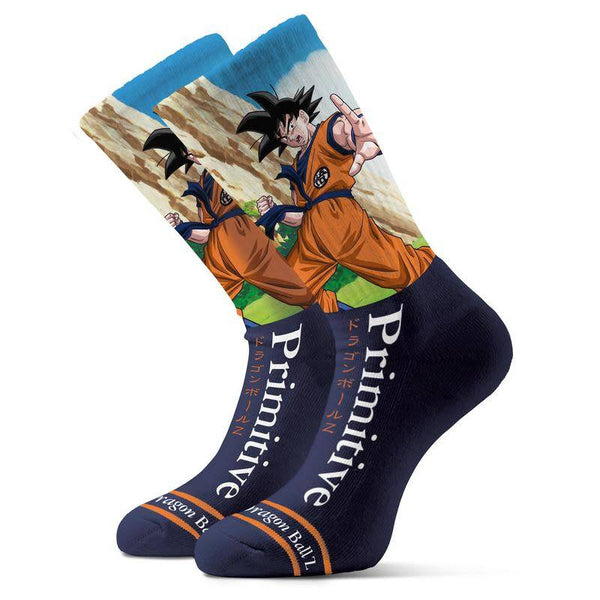 The PRIMITIVE X DRAGONBALL Z GOKU BATTLE SOCK by PRIMITIVE features navy socks with Goku in an action pose and "Primitive" plus "Dragon Ball Z" text on the side.