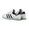 A pair of white and black ADIDAS JASON DILL SAMBA sneakers.