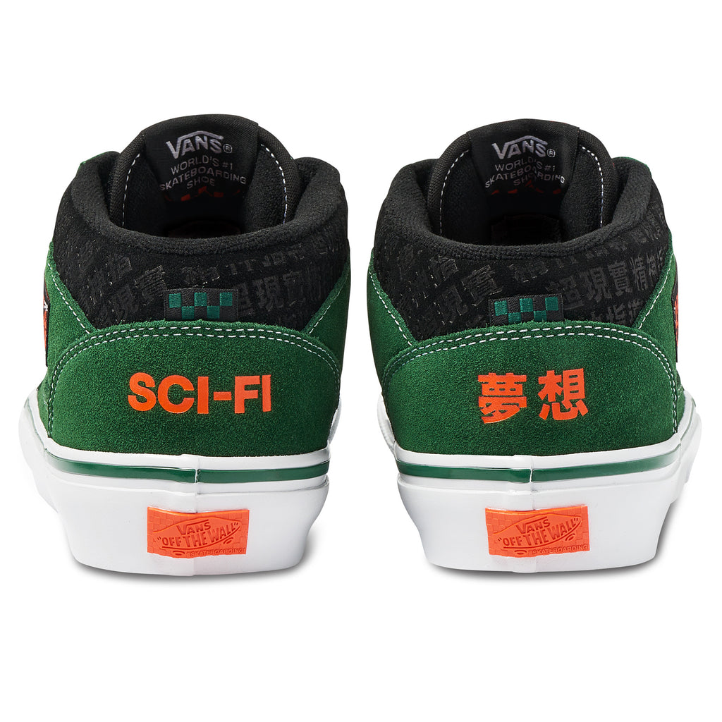 A pair of VANS SKATE X SCI-FI FANTASY HALF CAB '92 VCU GREEN / WHITE shoes with orange lettering.