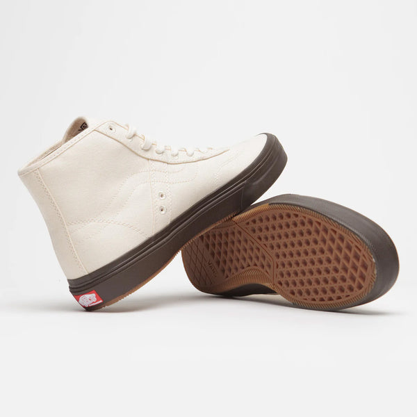 A pair of VANS SKATE X QUASI CROCKETT HIGH DECON WHITE shoes with brown soles.