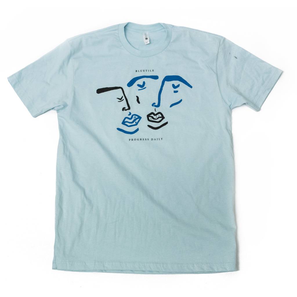 A BLUETILE X PROGRESS DAILY TWO COLOR LIGHT BLUE t-shirt featuring two faces, made by Bluetile Skateboards.