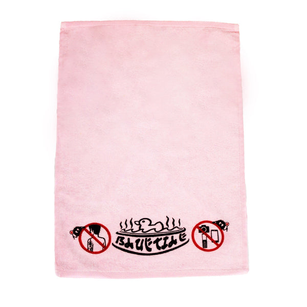 A pink BLUETILE RUBBER DUCKY HAND TOWEL with a no smoking sign on it.