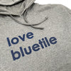 A Bluetile Skateboards grey sweatshirt with the words love bluette on it.
