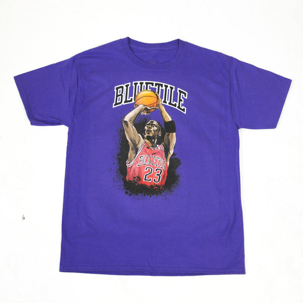 A BLUETILE JUMP SHOT T-SHIRT PURPLE with an image of a basketball player executing a jump shot.