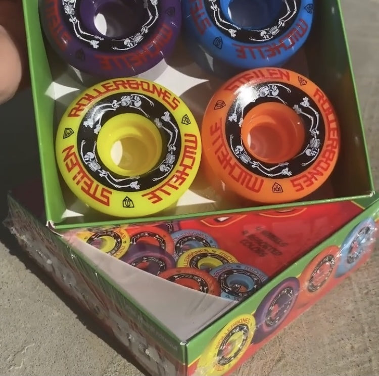 Two boxes of the colorful skateboards wheels.