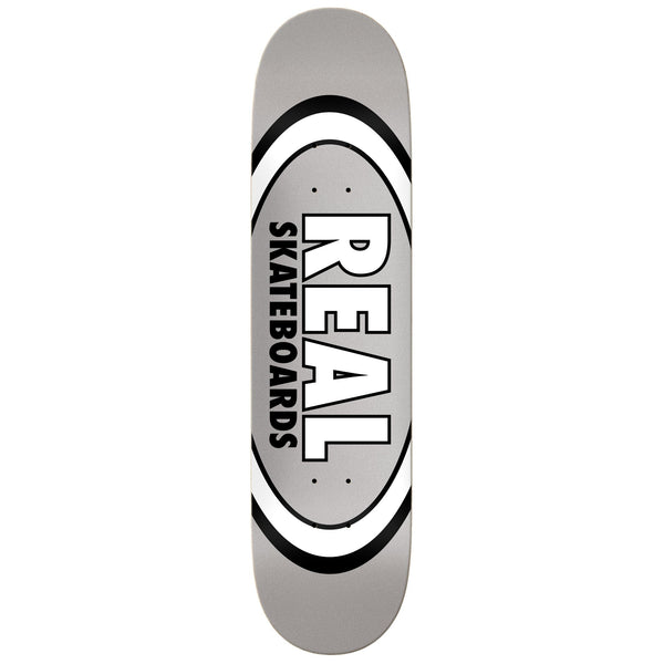 The REAL CLASSIC OVAL 7.75 MID GREY skateboard deck features a sleek silver finish and bold black logo with "REAL SKATEBOARDS" in striking capital letters.