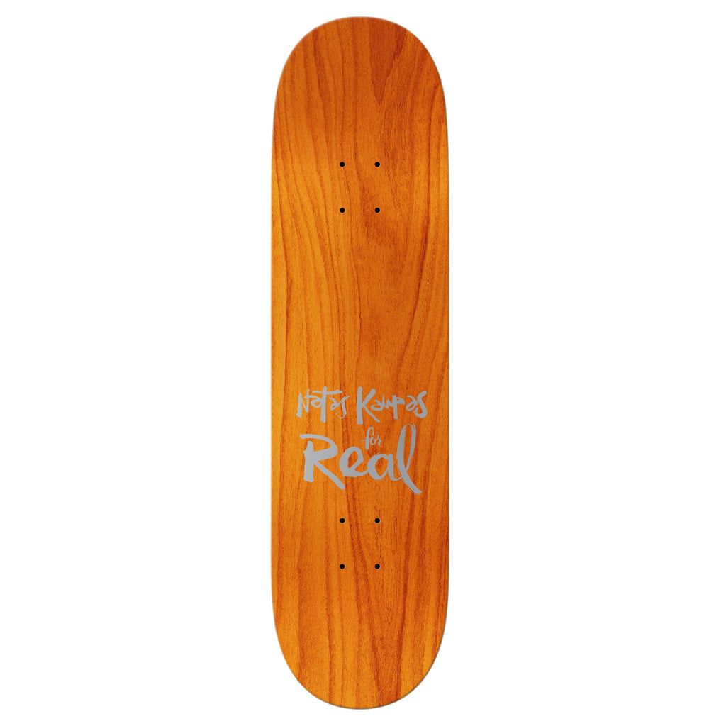 the top of a orange stained skateboard deck with "Natas Kaupas for Real" text