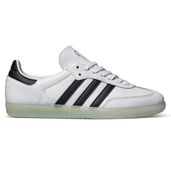 A black and white ADIDAS JASON DILL SAMBA WHITE / CORE BLACK / GOLD METALLIC shoe.
