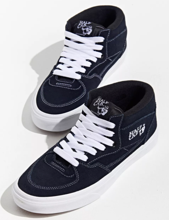 A pair of black and white VANS HALF CAB NAVY / WHITE sneakers on a white surface.