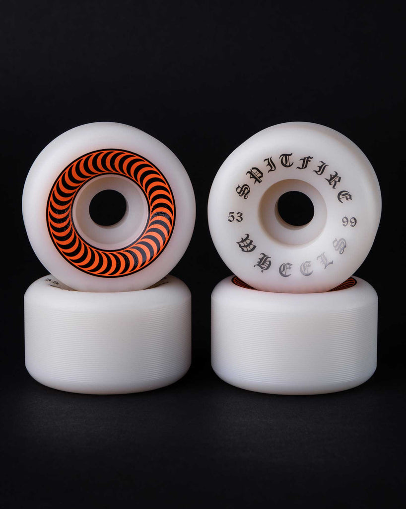 Four stacked white SPITFIRE O.G. CLASSICS 99A 53MM wheels with graphic designs, against a black background.