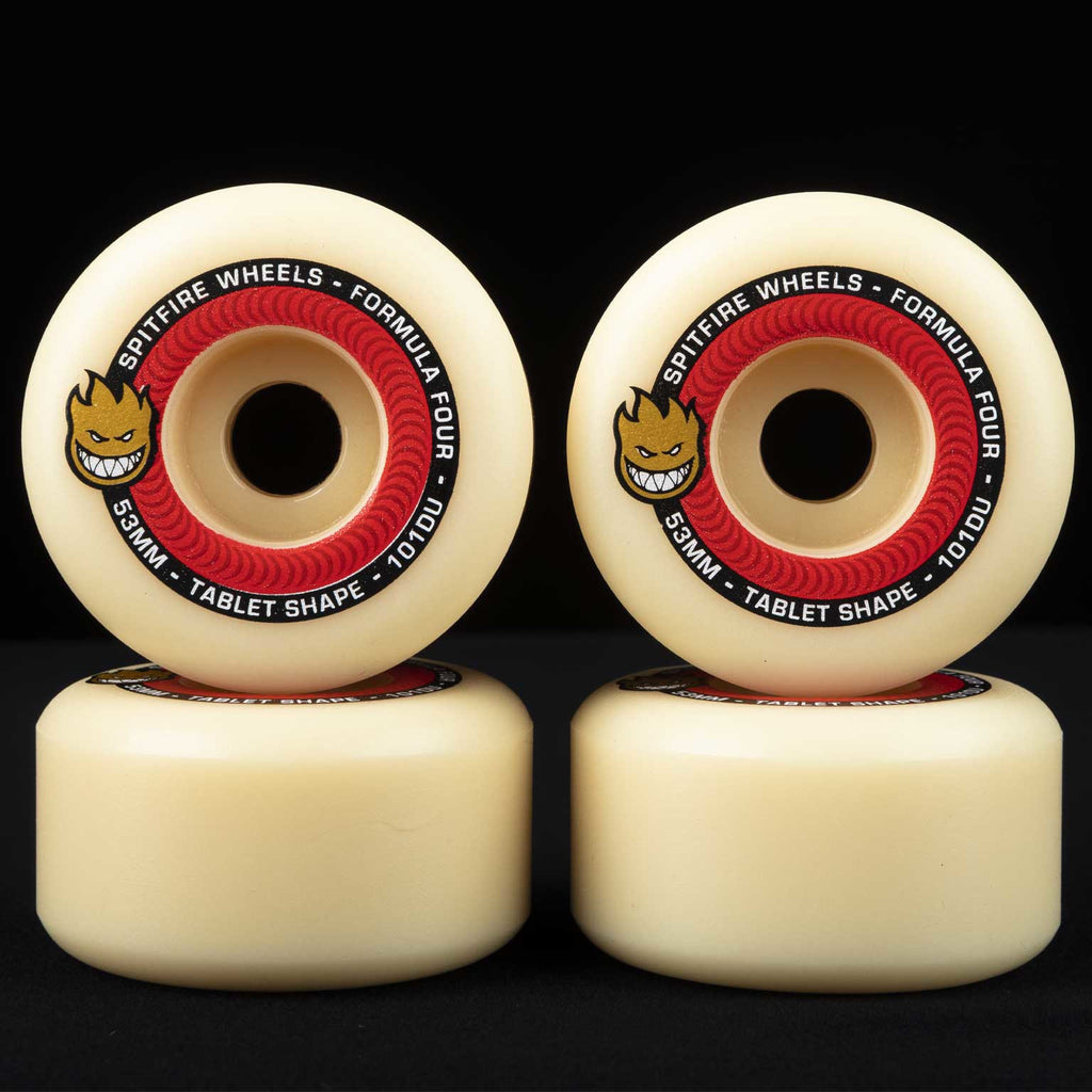 Four SPITFIRE FORMULA FOUR TABLETS 101D 55MM skateboard wheels stacked in pairs against a black background.