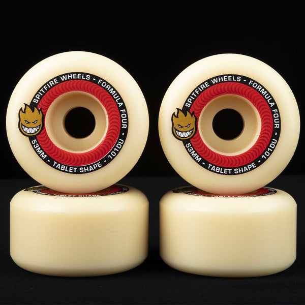 Four SPITFIRE FORMULA FOUR TABLETS 101D 53MM skateboard wheels arranged in two rows against a black background.