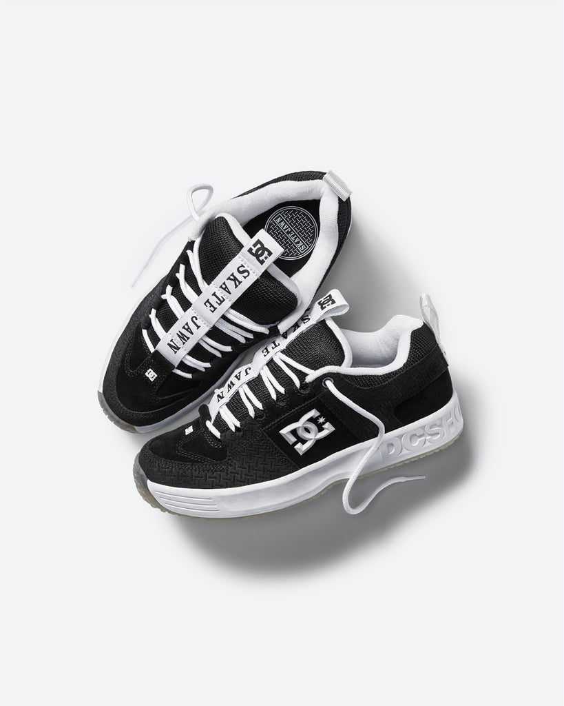 A pair of black and white DC Lynx OG Skate Jawn sneakers on a white surface.