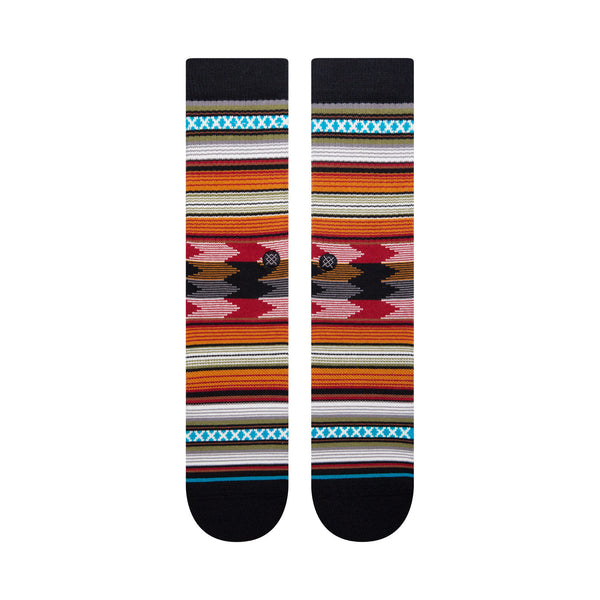 A pair of large STANCE socks with a colorful southwestern pattern on a white background.