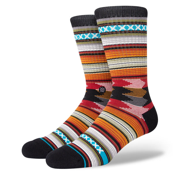 A pair of colorful patterned large STANCE SOCKS BARON BLACK with Baron Black heels and toes.