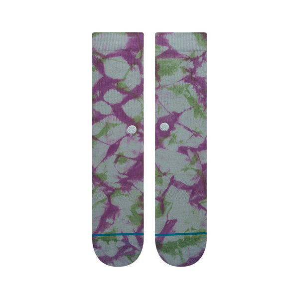 A pair of STANCE socks with a large purple and elation blue floral pattern.