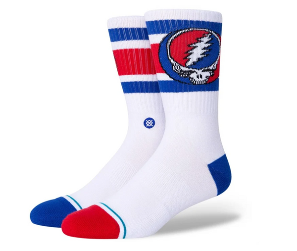 A pair of STANCE SOCKS STEAL YOURE BOYD MED with blue and red stripes and a circular grateful dead emblem on the side.